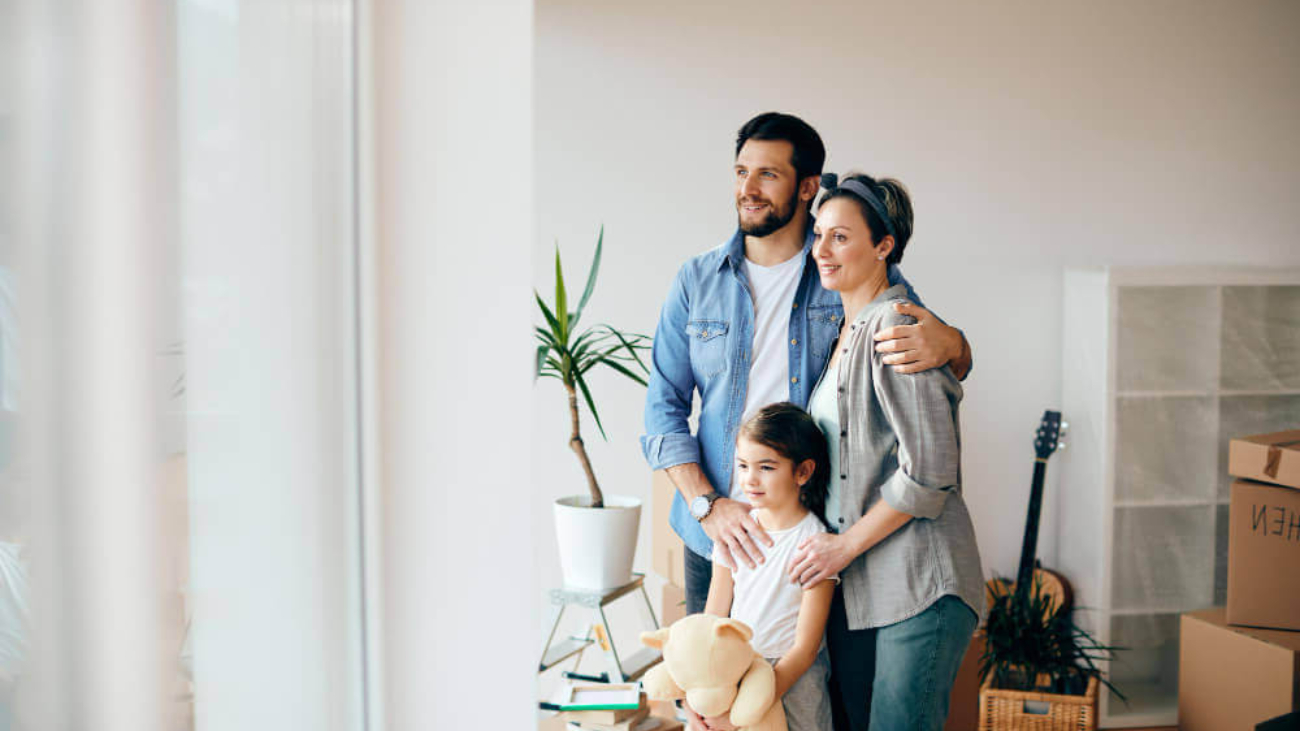 happy-family-looking-through-window-while-moving-into-new-home-1-1